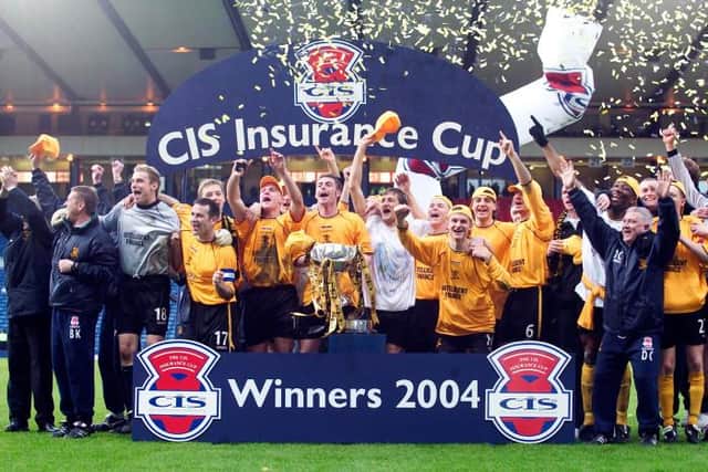 The Livingston squad celebrate after winning the CIS Cup in March 2014