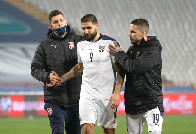 Aleksandar Mitrovic is consoled - but he was not the brunt of the blame in the Serbian press following the defeat  (Photo by Srdjan Stevanovic/Getty Images)