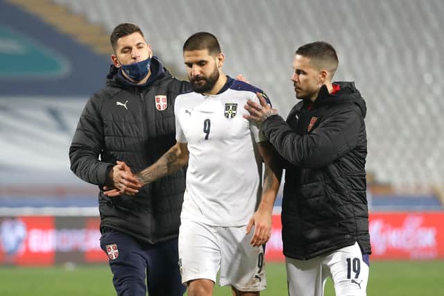 Aleksandar Mitrovic is consoled - but he was not the brunt of the blame in the Serbian press following the defeat  (Photo by Srdjan Stevanovic/Getty Images)