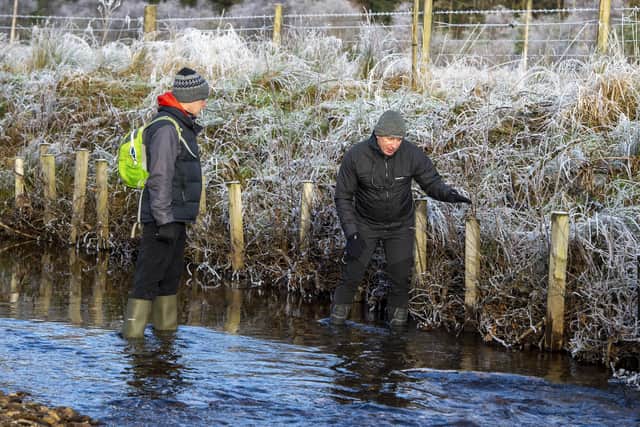 Dom Hall from Loch Lomond and the Trossachs National Park Authority and Tim King of the Lochgoil Community Trust inspect 'green revetment' work to help stabilise the banks of the River Goil. Picture: Chris Watt