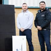 Edinburgh Boiler Company (EBC) managing director Mark Glasgow (right) and operations director Dougie Bell, alongside solar panels, boilers, an inverter and heat pumps.