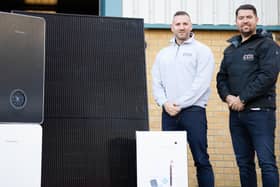 Edinburgh Boiler Company (EBC) managing director Mark Glasgow (right) and operations director Dougie Bell, alongside solar panels, boilers, an inverter and heat pumps.