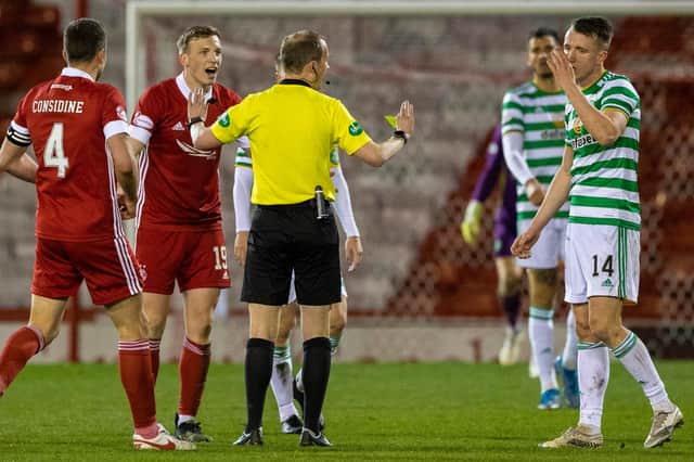 Aberdeen's players protest as David Turnbull is booked by referee Willie Collum during Celtic's trip to Pittodrie. Picture: SNS
