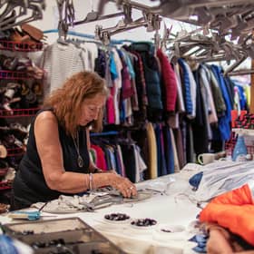 Barbara Myloff, 76, organising items in an Oxfam shop in Lochee, Dundee.