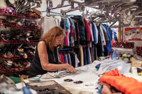 Barbara Myloff, 76, organising items in an Oxfam shop in Lochee, Dundee.
