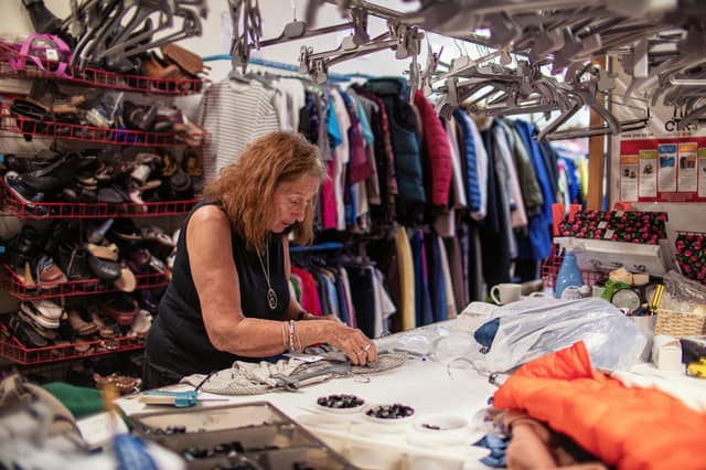 Barbara Myloff, 76, organising items in an Oxfam shop in Lochee, Dundee.