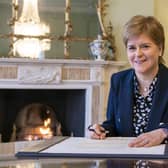 Outgoing First Minster of Scotland Nicola Sturgeon signs her official resignation letter to King Charles III in the Drawing Room at Bute House in Edinburgh. Picture date: Tuesday March 28, 2023.
