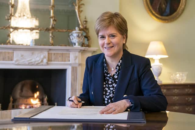 Outgoing First Minster of Scotland Nicola Sturgeon signs her official resignation letter to King Charles III in the Drawing Room at Bute House in Edinburgh. Picture date: Tuesday March 28, 2023.
