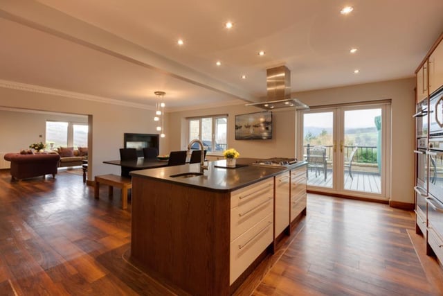 The dining kitchen has fitted base/wall and drawer units incorporating granite work surfaces, upstands and 1.5 bowl sink. A central island has a preparation sink and provides additional storage. Appliances include a six-ring gas hob with extractor hood above, two combination ovens (one with steam function) and additional compact combination oven. A microwave, two dishwashers and a wine cooler are all integrated.