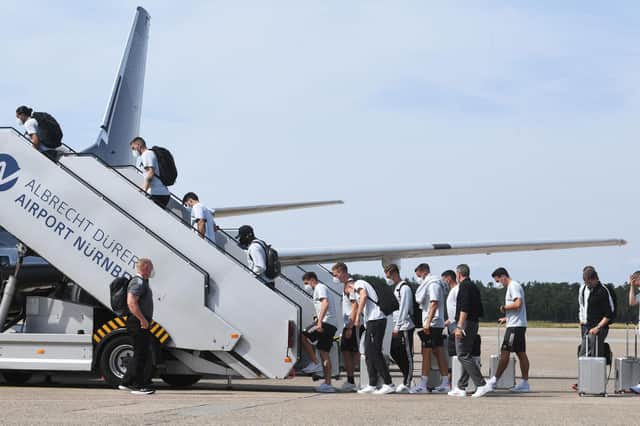 Germany's players and staff board a plane bound for England on the tarmac of Nuremberg Airport.