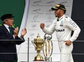 Jackie Stewart applauds Lewis Hamilton's British Grand Prix win in 2017.