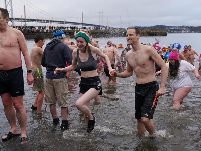 People take part in the Loony Dook New Year's Day dip in the Firth of Forth at South Queensferry,