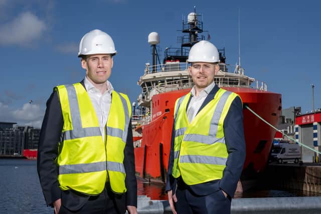 Chief commercial officer Michael Gordon (left) and charterer Matthew Coletta (right) in front of the Grampian Freedom. Picture: Michal Wachucik/Abermedia