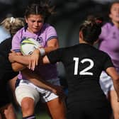 Scotland's Lisa Thomson (C) is tackled by New Zealand's Caity Mattinson (L) and Ayesha Leti-L'iga (R) during the New Zealand 2021 Womens Rugby World Cup Pool match between New Zealand and Scotland at the Northland Events Centre in Whangarei on October 22, 2022.
