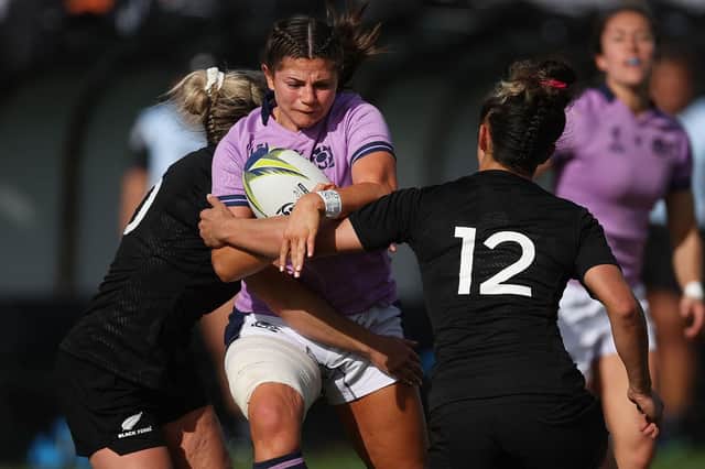 Scotland's Lisa Thomson (C) is tackled by New Zealand's Caity Mattinson (L) and Ayesha Leti-L'iga (R) during the New Zealand 2021 Womens Rugby World Cup Pool match between New Zealand and Scotland at the Northland Events Centre in Whangarei on October 22, 2022.
