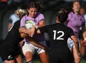 Scotland's Lisa Thomson (C) is tackled by New Zealand's Caity Mattinson (L) and Ayesha Leti-L'iga (R) during the New Zealand 2021 Womens Rugby World Cup Pool match between New Zealand and Scotland at the Northland Events Centre in Whangarei on October 22, 2022.