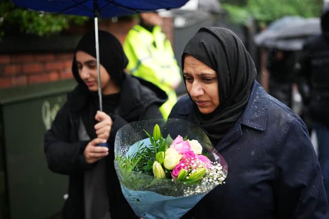 People come to leave flowers and pay their respects before a vigil to be held after the attack at the Heaton Park Hebrew Congregation Synagogue in Manchester. Picture: Christopher Furlong/Getty Images