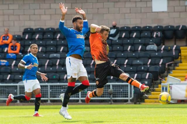 Jamie Robson gets in ahead of Rangers defender Connor Goldson to score for Dundee United at Tannadice. (Photo by Ross Parker / SNS Group)