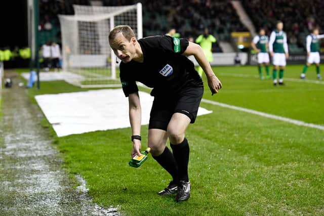 Referee Wiillie Collum removes a bottle from the pitch, which was thrown from by a Hibs supporter, in their Scottish Cup quarter-final of March 2019. (Phot by Rob Casey/SNS Group).