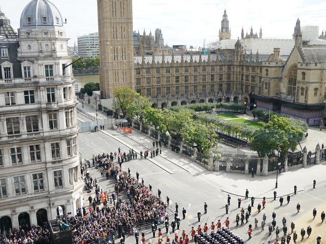 The State Gun Carriage carries the coffin of Queen Elizabeth II, draped in the Royal Standard with the Imperial State Crown and the Sovereign's orb and sceptre, in the Ceremonial Procession following her State Funeral at Westminster Abbey, London. Picture date: Monday September 19, 2022.