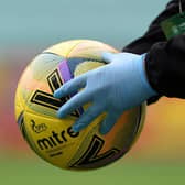 The matchball is disinfected during a Scottish Premiership match
(Ross MacDonald / SNS Group)