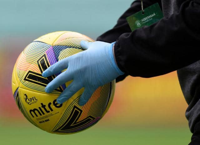 The matchball is disinfected during a Scottish Premiership match
(Ross MacDonald / SNS Group)