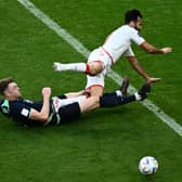 Harry Souttar puts in a crunching tackle during Australia's 1-0 win over Tunisia.