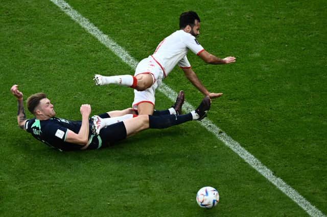 Harry Souttar puts in a crunching tackle during Australia's 1-0 win over Tunisia.