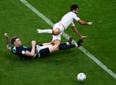 Harry Souttar puts in a crunching tackle during Australia's 1-0 win over Tunisia.