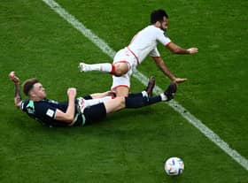 Harry Souttar puts in a crunching tackle during Australia's 1-0 win over Tunisia.