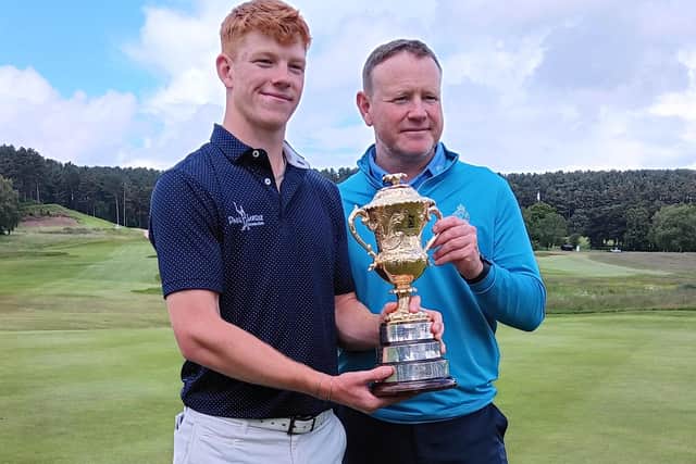 Blairgowrie's Gregor Graham shows off the Brabazon Trophy with his dad and caddie, Stuart, at Hollinwell in Nottinghamshire.