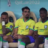 Neymar (left) sits on the bench after being substituted with an injury during the win over Serbia. (Photo by ADRIAN DENNIS/AFP via Getty Images)