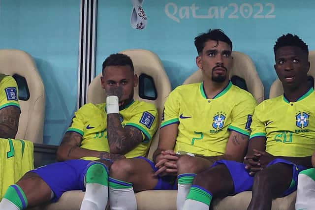 Neymar (left) sits on the bench after being substituted with an injury during the win over Serbia. (Photo by ADRIAN DENNIS/AFP via Getty Images)