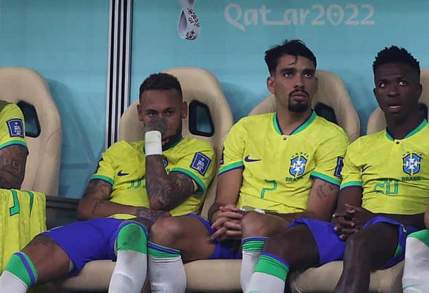 Neymar (left) sits on the bench after being substituted with an injury during the win over Serbia. (Photo by ADRIAN DENNIS/AFP via Getty Images)