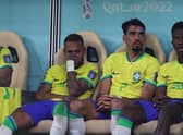 Neymar (left) sits on the bench after being substituted with an injury during the win over Serbia. (Photo by ADRIAN DENNIS/AFP via Getty Images)