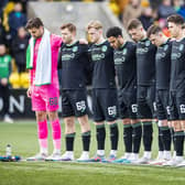 The Hibs players stand for a minute's silence for their former chairman Ron Gordon, who died last month.