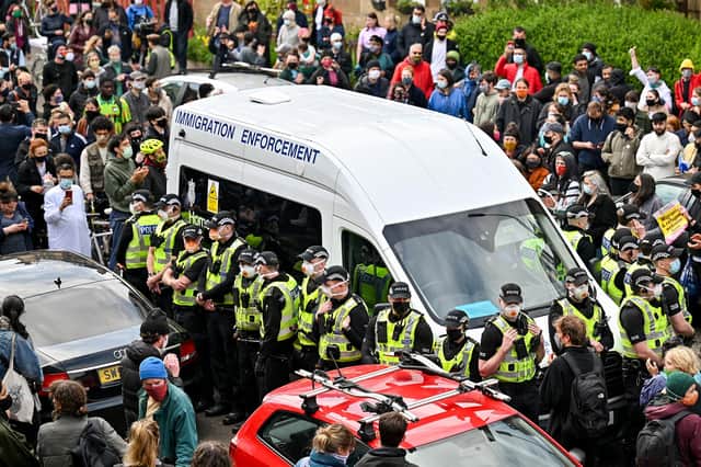 Protesters block a UK Home Office van to prevent it leaving Kenmure Street in Glasgow