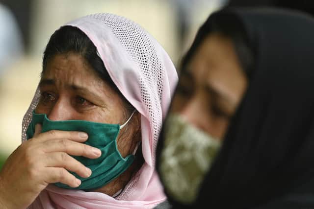 Afghan women weep outside the US Embassy in New Delhi, India, after applying for a visa (Picture: Money Sharma/AFP via Getty Images)