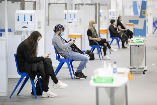 Health and social care staff wait in the rest area after receiving their coronavirus vaccines at the NHS Louisa Jordan Hospital in Glasgow.