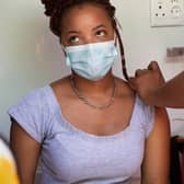 A woman is vaccinated in an ambulance converted to facilitate Covid vaccinations in South Africa