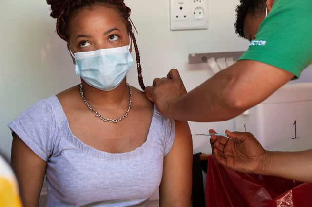 A woman is vaccinated in an ambulance converted to facilitate Covid vaccinations in South Africa