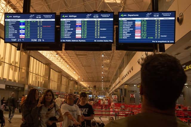 People look at a board displaying cancelled and delayed flights at Tenerife SouthReina Sofia Airport (Photo: DESIREE MARTIN/AFP via Getty Images)