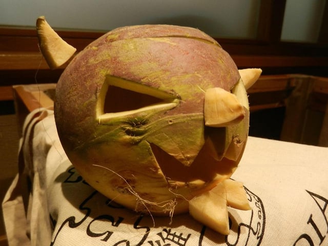 Samhuinn describes the ancient Celtic festival that took place to mark the end of summer and the onset of the cold, dark winter. At this time it was thought that the veil between our world and the spirits' thinned, and therefore people carved masks like the turnip above so they could blend in with evil spirits and not be targeted by them.
