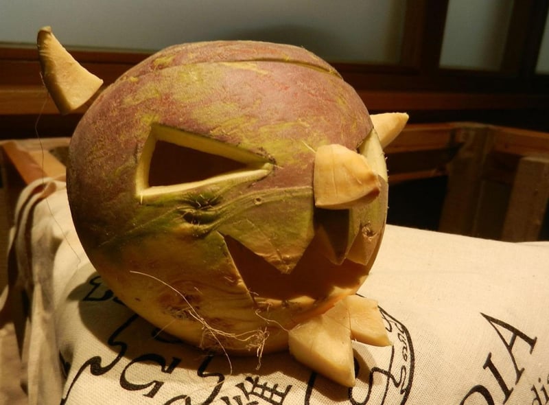 Samhuinn describes the ancient Celtic festival that took place to mark the end of summer and the onset of the cold, dark winter. At this time it was thought that the veil between our world and the spirits' thinned, and therefore people carved masks like the turnip above so they could blend in with evil spirits and not be targeted by them.