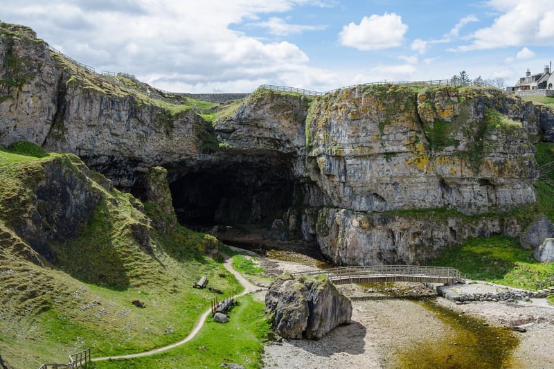 This natural sea cave is situated one mile to the East of Durness village which lies in Sutherland in the Highlands. It is thought the name “smoo” comes from the Norse word “smjugg” which refers to a hole or hiding place. In Scottish mythology, the devil himself was said to hide in the cave before one fateful encounter with the Wizard of Reay (Donald Mackay) who outfoxed him. According to Smoo Cave tours the site “is fully accessible 365 days a year public access with a walkway into the waterfall chamber, free of charge.”