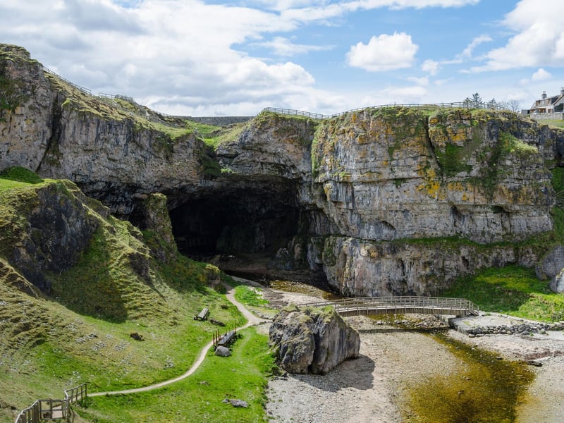 This natural sea cave is situated one mile to the East of Durness village which lies in Sutherland in the Highlands. It is thought the name “smoo” comes from the Norse word “smjugg” which refers to a hole or hiding place. In Scottish mythology, the devil himself was said to hide in the cave before one fateful encounter with the Wizard of Reay (Donald Mackay) who outfoxed him. According to Smoo Cave tours the site “is fully accessible 365 days a year public access with a walkway into the waterfall chamber, free of charge.”