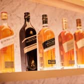FTSE-100 spirits giant Diageo has a vast portfolio that includes Johnnie Walker whisky, pictured. The group has almost 30 malt distilleries in Scotland.