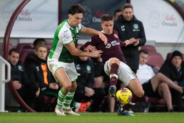 Hibs' Joe Newell and Hearts' Cammy Devlin clash during the last derby at Tynecastle.