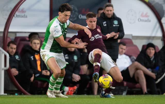 Hibs' Joe Newell and Hearts' Cammy Devlin clash during the last derby at Tynecastle.