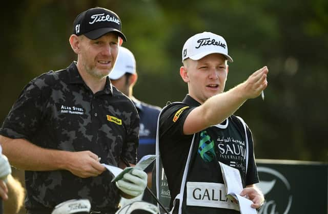 Stephen Gallacher talks tactics with his son/caddie Jack on the ninth tee in the second round of the Saudi International powered by SoftBank Investment Advisers at Royal Greens Golf and Country Club in King Abdullah Economic City. Picture: Ross Kinnaird/Getty Images.